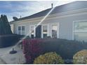 Features a cozy backyard patio with outdoor seating surrounded by vibrant landscaping at 905 Roxburgh Ave, Rock Hill, SC 29732