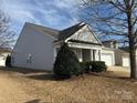 Charming single-story home featuring a well-manicured lawn, attached garage, and classic architectural details at 905 Roxburgh Ave, Rock Hill, SC 29732