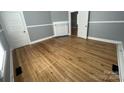 Empty bedroom with hardwood floors, fresh paint, and natural light at 915 Spruce St, Albemarle, NC 28001