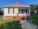 Inviting single-story home with a well-maintained lawn and brick foundation at 915 Spruce St, Albemarle, NC 28001