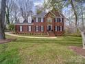 Charming two-story brick home with black shutters and a well-manicured lawn at 915 Waterview Ln, Monroe, NC 28110