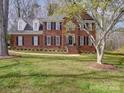 Charming two-story brick home with black shutters and a well-manicured lawn at 915 Waterview Ln, Monroe, NC 28110