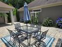 Inviting patio area featuring an outdoor dining set, umbrella, and colorful rug, ideal for relaxing and enjoying the outdoors at 1112 Avalon Pl, Stallings, NC 28104