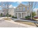 Charming two-story home featuring a welcoming front porch and well-maintained landscaping at 11122 Aprilia Ln, Cornelius, NC 28031