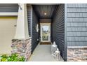 Welcoming front entrance with decorative lanterns and stone-accented pillars at 11810 Red Leaf Dr, Charlotte, NC 28215