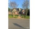 Charming brick home featuring manicured lawn, lovely landscaping, and inviting entrance at 1308 Moonshadow Ln, Shelby, NC 28150