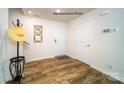 Bright foyer with wood-look floors, coat rack, and staircase leading to the upper level at 1443 Mammoth Rd, Hickory, NC 28602