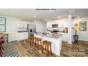 Modern kitchen with white cabinets, granite countertops, and a center island with bar seating at 1443 Mammoth Rd, Hickory, NC 28602