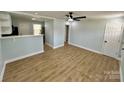 Bright and airy living room with wood flooring, a ceiling fan, and an open concept layout with a view of the kitchen at 1946 Academy St, Charlotte, NC 28205