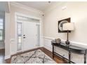 Bright foyer featuring hardwood floors, elegant console table, and stylish mirror at 2110 Capricorn Ave, Indian Trail, NC 28079
