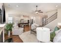 Open concept living room showcasing hardwood floors and seamless flow to the kitchen at 2110 Capricorn Ave, Indian Trail, NC 28079