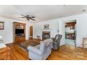 Cozy living room with fireplace, ceiling fan and hardwood floors, adjacent to the kitchen at 230 Dunham Ave, Salisbury, NC 28146