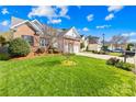 Beautifully landscaped front yard showcasing a well-maintained lawn and mature trees in a residential neighborhood at 2966 Huckleberry Hill Dr, Fort Mill, SC 29715