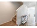 Light-filled foyer with hardwood floors, staircase, and stylish console table at 3077 Light Ridge Sw Ct, Concord, NC 28027