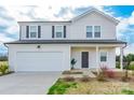 Charming two-story home boasts an attached garage, tidy landscaping, and welcoming entrance at 3077 Light Ridge Sw Ct, Concord, NC 28027