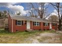 Brick duplex with tidy lawn, showing black shutters and twin entryways for separate living at 326 Mountain View St, Gastonia, NC 28052