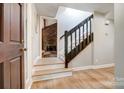 Hallway with hardwood floors, stairs, and view of a fireplace at 4124 Woodfox Dr, Charlotte, NC 28277