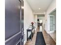 Inviting entryway with hardwood floors, decorative table, and view into the living area at 7027 Waterwheel St, Concord, NC 28025