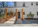 Covered walkway with wood beams leading to the front door of a beautifully renovated home at 7214 Benita Dr, Charlotte, NC 28212