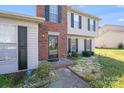 Welcoming front entrance with a decorative door and manicured landscaping at 7619 Woodknoll Dr, Charlotte, NC 28217