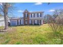 Inviting two-story home with a combination of siding and brick facade at 7619 Woodknoll Dr, Charlotte, NC 28217