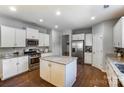 Bright kitchen with white cabinets, stainless steel appliances, and a granite-topped island at 100 Marabou Ct, Mount Holly, NC 28120