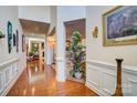 Grand hallway with hardwood floors, wainscoting, and access to multiple rooms at 10202 Little Whiteoak Rd, Charlotte, NC 28215