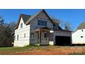 Unfinished home showing the two-car garage and covered porch at 128 Kepli Way, Mooresville, NC 28115