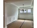 Dining room with modern chandelier, decorative wainscoting, and large windows at 1453 Ardmore Dr # 240, Sherrills Ford, NC 28673