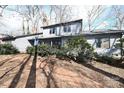 Charming home with a brick path leading to the covered entrance, surrounded by mature trees at 1793 Fairway Dr, Newton, NC 28658