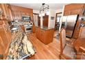 Spacious kitchen featuring wooden cabinets, stainless steel appliances, and granite countertops, perfect for cooking and entertaining at 1793 Fairway Dr, Newton, NC 28658