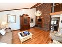 Elegant living room featuring a cozy fireplace, hardwood floors, and a decorative chandelier for a warm ambiance at 1793 Fairway Dr, Newton, NC 28658