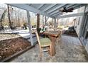 Inviting covered patio with stone floors, a ceiling fan, and a view of the backyard deck at 1793 Fairway Dr, Newton, NC 28658