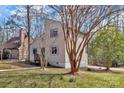 This home's exterior is enhanced by mature trees and a lush lawn at 2406 Brook Canyon Dr, Charlotte, NC 28212