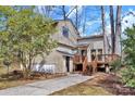 Back of the house with a wooden porch and stairs and a small garage area on the side at 2406 Brook Canyon Dr, Charlotte, NC 28212