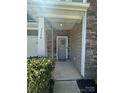 View of the front porch with a decorative door and landscaping at 2640 Southern Trace Dr, Waxhaw, NC 28173