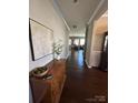 View down a long hallway with hardwood floors and an entry table at 2640 Southern Trace Dr, Waxhaw, NC 28173