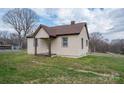 Quaint single-level home with siding, a covered porch, and a spacious front yard at 2915 Spencer Ne Rd, Conover, NC 28613