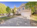 The house features a concrete driveway, lush green lawn and beautiful landscape at 4528 Potters Glen Rd, Charlotte, NC 28269