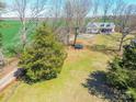 Large, green backyard featuring mature trees, providing shade and privacy for outdoor activities and recreation at 4605 Austin Rd, Monroe, NC 28112