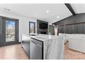 Contemporary kitchen island featuring marble countertop and sleek dishwasher at 5501 Joyce Dr, Charlotte, NC 28215
