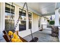 Covered front porch with a swing, offering a relaxing outdoor space to enjoy the neighborhood views at 5807 Mctaggart Ln, Charlotte, NC 28269