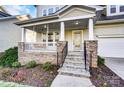 Inviting front porch featuring stone columns, stylish railings, and a welcoming entrance to the home at 5807 Mctaggart Ln, Charlotte, NC 28269