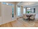 Dining room features wood floors, large windows with curtains, and a chandelier at 9607 Kestral Ridge Dr, Charlotte, NC 28269