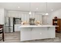 Beautiful kitchen featuring stainless appliances, a large island, pendant lighting, and a stylish backsplash at 1032 Barnette Farm Ln, Monroe, NC 28110
