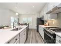 Bright kitchen with an island, stainless steel appliances, and an adjacent dining area at 1032 Barnette Farm Ln, Monroe, NC 28110