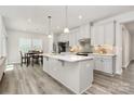 Bright kitchen featuring a spacious island, stainless steel appliances, pendant lighting, and modern countertops at 1032 Barnette Farm Ln, Monroe, NC 28110