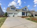 Beautiful home boasting a three-car garage, neutral siding, and a well manicured lawn at 10547 Skipping Rock Nw Ln, Concord, NC 28027