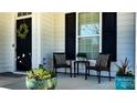 Cozy front porch featuring comfortable seating and decorative planters, perfect for relaxing at 10547 Skipping Rock Nw Ln, Concord, NC 28027