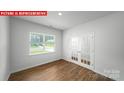 Bright bedroom features a window with natural light and french doors at 11135 Cardinal Creek Ave, Charlotte, NC 28215